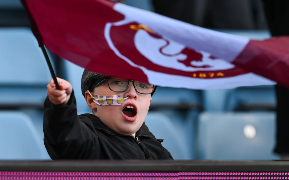 Kid with an Aston Villa flag